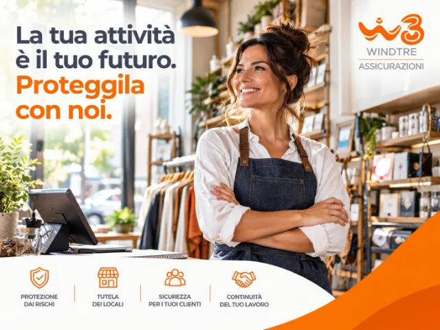 Titolare sorridente all'interno del proprio negozio, con prodotti esposti, bancone vendita e logo WINDTRE dedicato alle assicurazioni per attività commerciali.